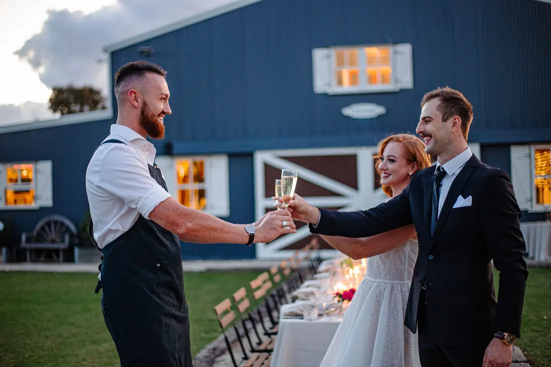 Wedding guests collecting drinks from The Barmen's mobile bar during a reception